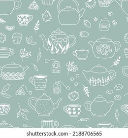 Seamless pattern with tea pots, cups, tea bags, sweets and berries on green background. Hand drawn doodle mugs. Vector illustration.