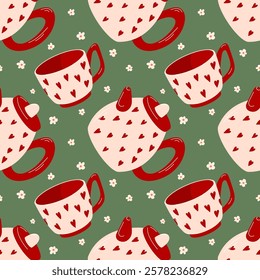 Seamless pattern with teapot and cup with red heart and daisy on green background in flat style. Perfect for home decor, textile and kitchen towel design.