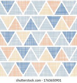 Seamless pattern of textile ikat triangles. Vector woven fabric texture. Repeating linen texture in blue and sand colors.