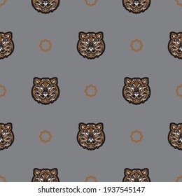 Seamless pattern with tiger face in colored Polynesian style. Good for clothing and textiles. Vector 