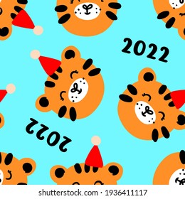 Seamless pattern with tiger faces in Christmas hats. Bright print New Year's Eve 2022 for the background of calendars with the Chinese symbol of the year