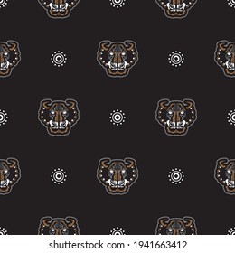 Seamless pattern with tiger head in simple boho style. Good covers, fabrics and printing. Vector 