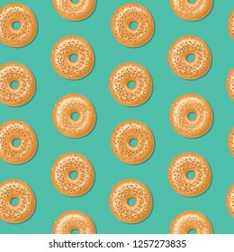 Seamless pattern with top view of fresh bagels, white and brown sesame seeds on top. Delicious breakfast. Vector seamless pattern.
