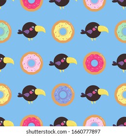 Seamless pattern with toucans and donuts. Cartoon baby repeat print.