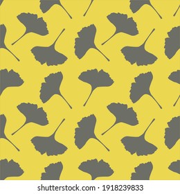 Seamless pattern in a trendy color yellow ginkgo leaves on a gray background