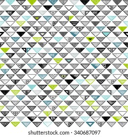 Seamless pattern of triangles black, blue and green colored.