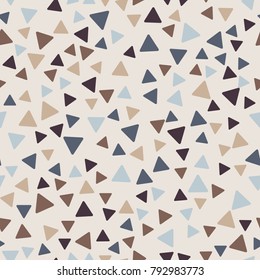 Seamless pattern. Triangles with rounded corners randomly scattered. Autumn colors.