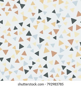 Seamless pattern. Triangles with rounded corners randomly scattered. Autumn colors.
