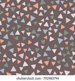 Seamless pattern. Triangles with rounded corners randomly scattered. Autumn colors.