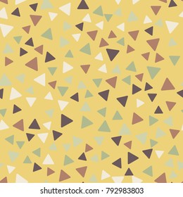 Seamless pattern. Triangles with rounded corners randomly scattered. Autumn colors.