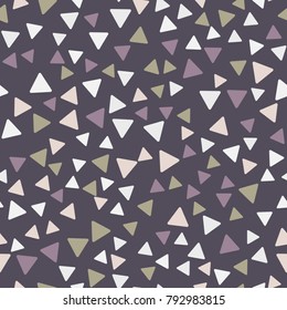 Seamless pattern. Triangles with rounded corners randomly scattered. Autumn colors.