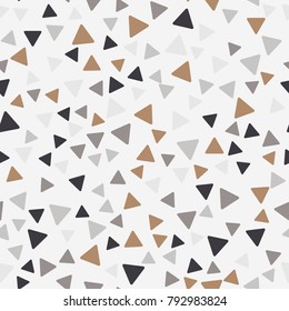 Seamless pattern. Triangles with rounded corners randomly scattered. Autumn colors.