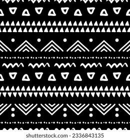 Seamless pattern with tribal aztec motives. Black and white abstract wallpaper in boho style with hand drawn elements.