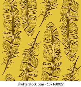 Seamless pattern of tribal bird feathers on yellow background