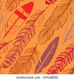 Seamless pattern of tribal bird feathers on orange background