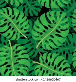 Seamless pattern with tropical leaves on a dark background.