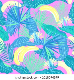 Seamless pattern of tropical leaves of palm tree, banana and flowers. Vector background.