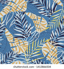 Seamless pattern with tropical leaves and plants on blue background. Vector design. Jungle print. Textiles and printing.