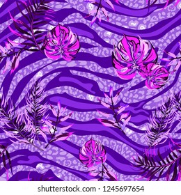 Seamless pattern with tropical leaves tiger stripes and jaguar spots
