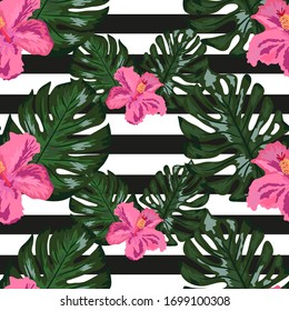 Seamless pattern with tropical orchid and hibiscus flowers, palm, banana and monstera leaves on striped background.