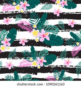 Seamless pattern with tropical palm leaves and flowers. Vector illustration.
