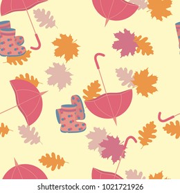 Seamless pattern with umbrella, baby boots and autumn leaves on a yellow background. For decorating textiles and packaging. Vector illustration.