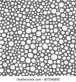 Seamless pattern of uneven circles. Hand drawn circles on gray background. Geometrical background.