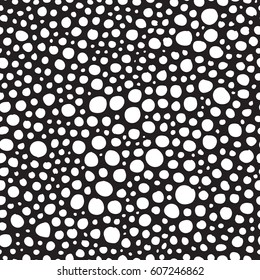 Seamless pattern with uneven circles. Hand drawn white circles on black background. Geometrical background.