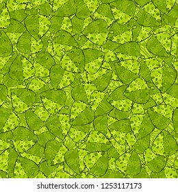 Seamless pattern of variegated green maple leaves lying on a background of square weaving. Camouflage.