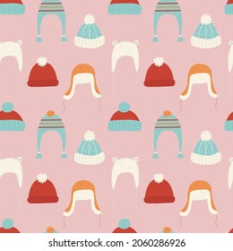 Seamless pattern with various cute hats. Pink background with doodle pom pom cap. Warm winter clother and accessories. Wrapping paper, wallpaper, fabric design