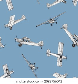 Seamless pattern of various drawn retro airplanes in flight in blue sky