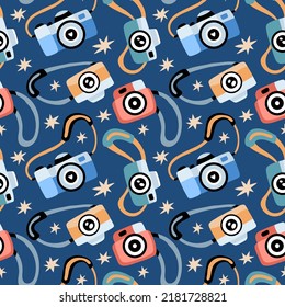 Seamless pattern with various photo cameras and stars. Texture for prints, fabrics, backgrounds and tourisric industries. Surface design. Tourism day, photography day. 