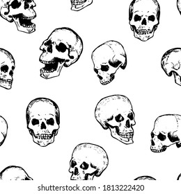 Seamless pattern of various scary human skulls. Hand drawn vector wallpaper in abstract engraving style. Halloween vintage outline background for design