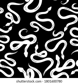 Seamless pattern with various snakes or serpents on black background. Botanical background on tropical theme. Black and white snake. Boho flat design for fabric, textile, wrapping paper, wallpaper