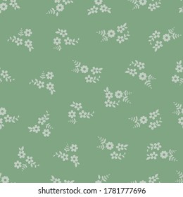 Seamless pattern vector design of small flowers on green background. The cute template for fashion prints, wallpaper, textile, and wrapping paper.