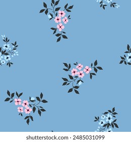 Seamless pattern vector design of small pink and white flowers on blue color background.
