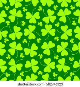 Seamless pattern. Vector illustration of clover leaves on green. St Patrick's Day background