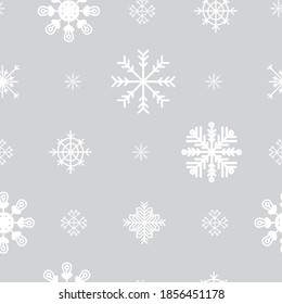 Seamless pattern vector illustration. Symmetric christmas snowflakes white color isolated on pale grey background. For wallpaper, decor, design, congratulation cards, design cushion, print.