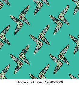Seamless pattern vector of pastel tribal style motif boomerang on pastel green background