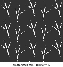 Seamless pattern with vector white bird tracks doodles on dark grey background. Fabric, template, textile, wrapping paper.