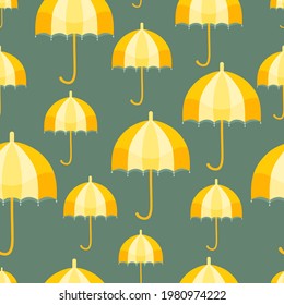 Seamless pattern with a vertically placed vintage umbrellas. Yellow umbrellas on the dark teal background. Design element for web and print usage.