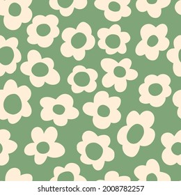 seamless pattern with vintage vector groovy flowers. modern elements. stylized flowers silhouettes on a  green background. surface design, textile, stationery, wrapping paper and covers