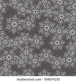 Seamless pattern. Wallpaper of snowflakes. Different of tones gray and white.