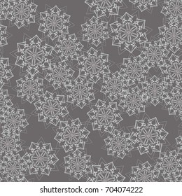 Seamless pattern. Wallpaper of snowflakes. Different of colors gray.