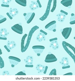 Seamless pattern with warm knitted clothes on a blue background in vector