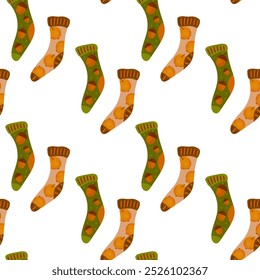 Seamless pattern of warm knitted socks with autumn acorns and apples. The concept is cozy