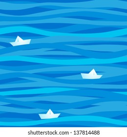 Seamless pattern with waves and paper boats.