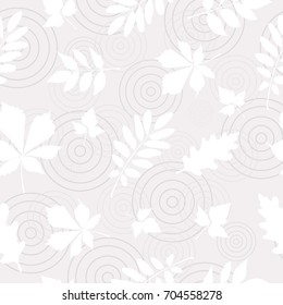 Seamless pattern of white autumn leaves on abstract puddle background.