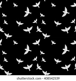 Seamless pattern with white birds on black background