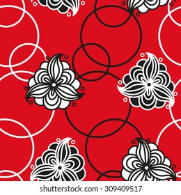 Seamless pattern with white and black flowers and circles on a red background